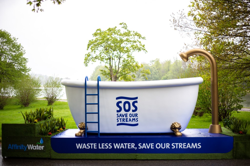 Large bathtub with Save Our Streams written on the side. 