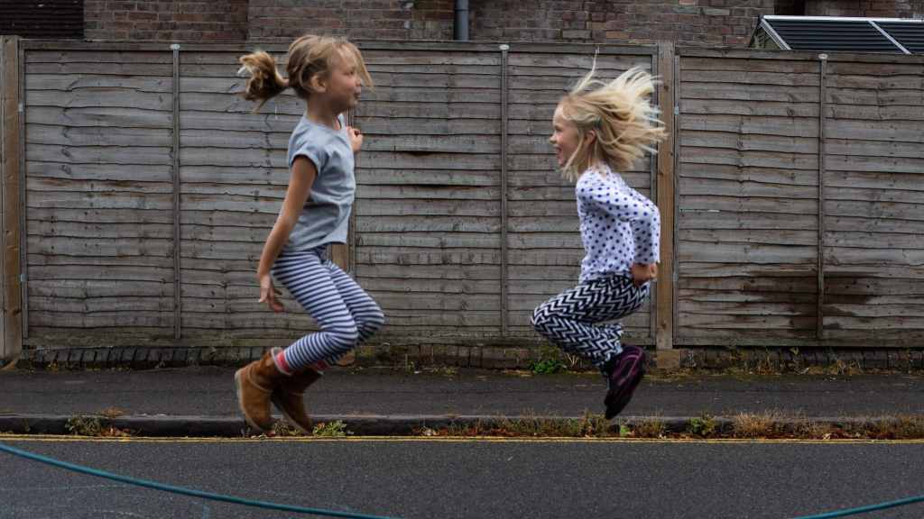 girls skipping on the closed road