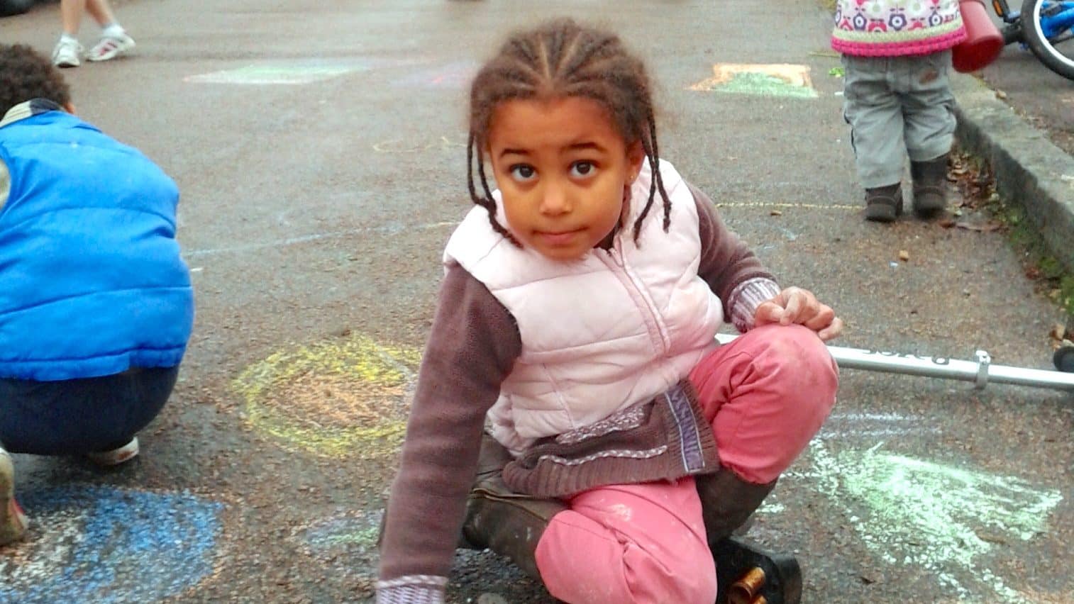 girl chalking while playing out

